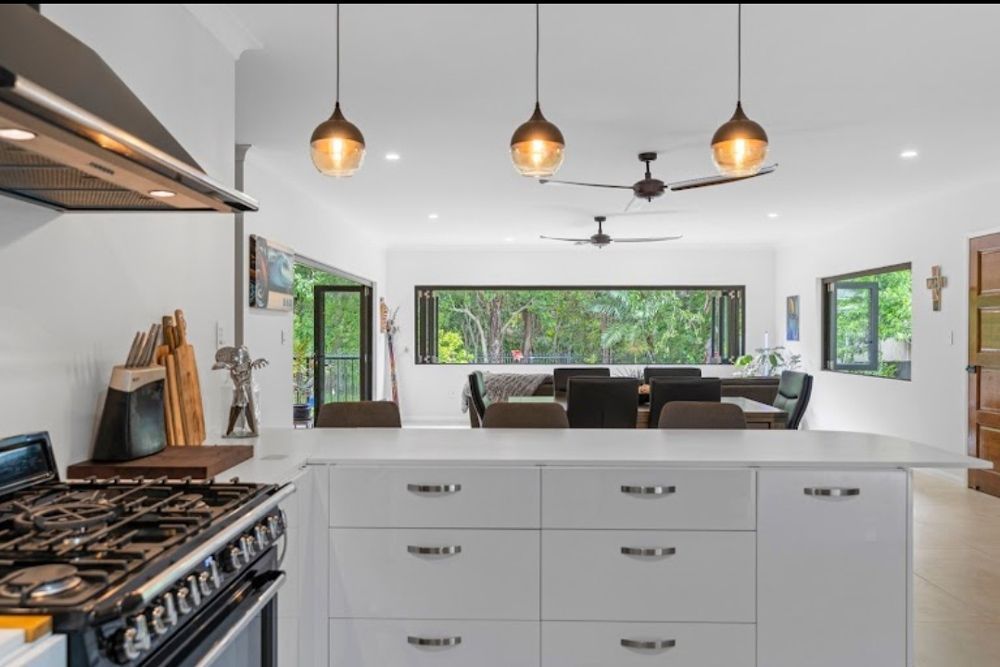 A Kitchen with A Stove and A Large Island in The Middle — Cairns Vacate Clean in Manunda, QLD