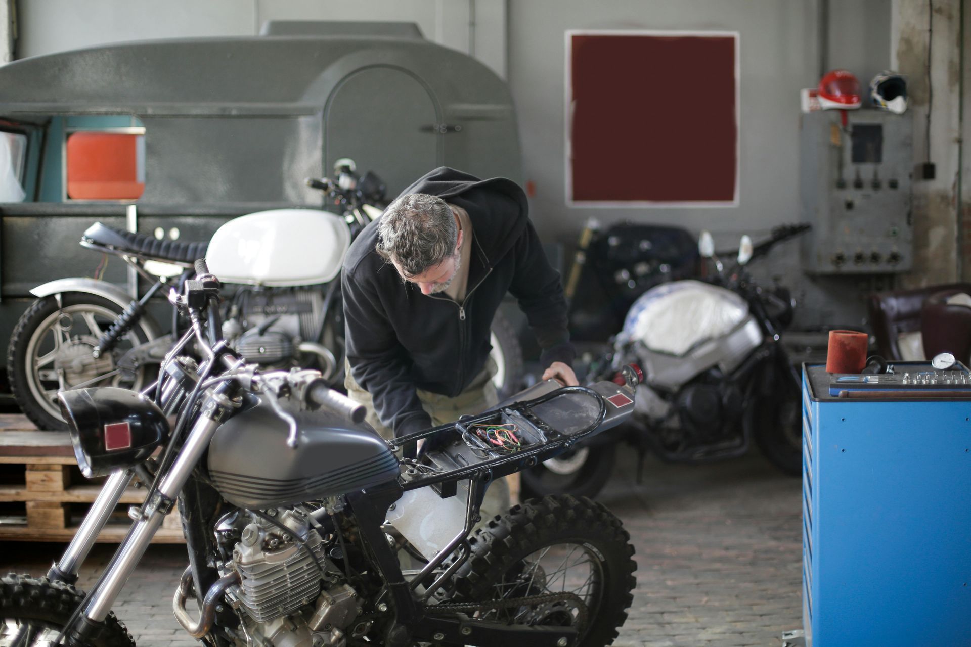 A man working on a motorcycle in a garage.