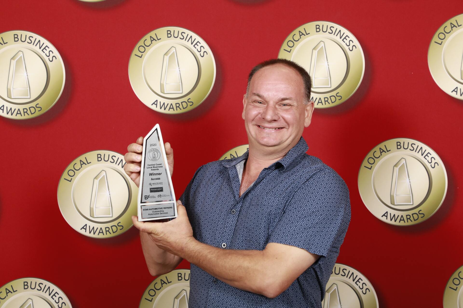 Our Team Holding a Local Business Award — About Us in West Gosford NSW