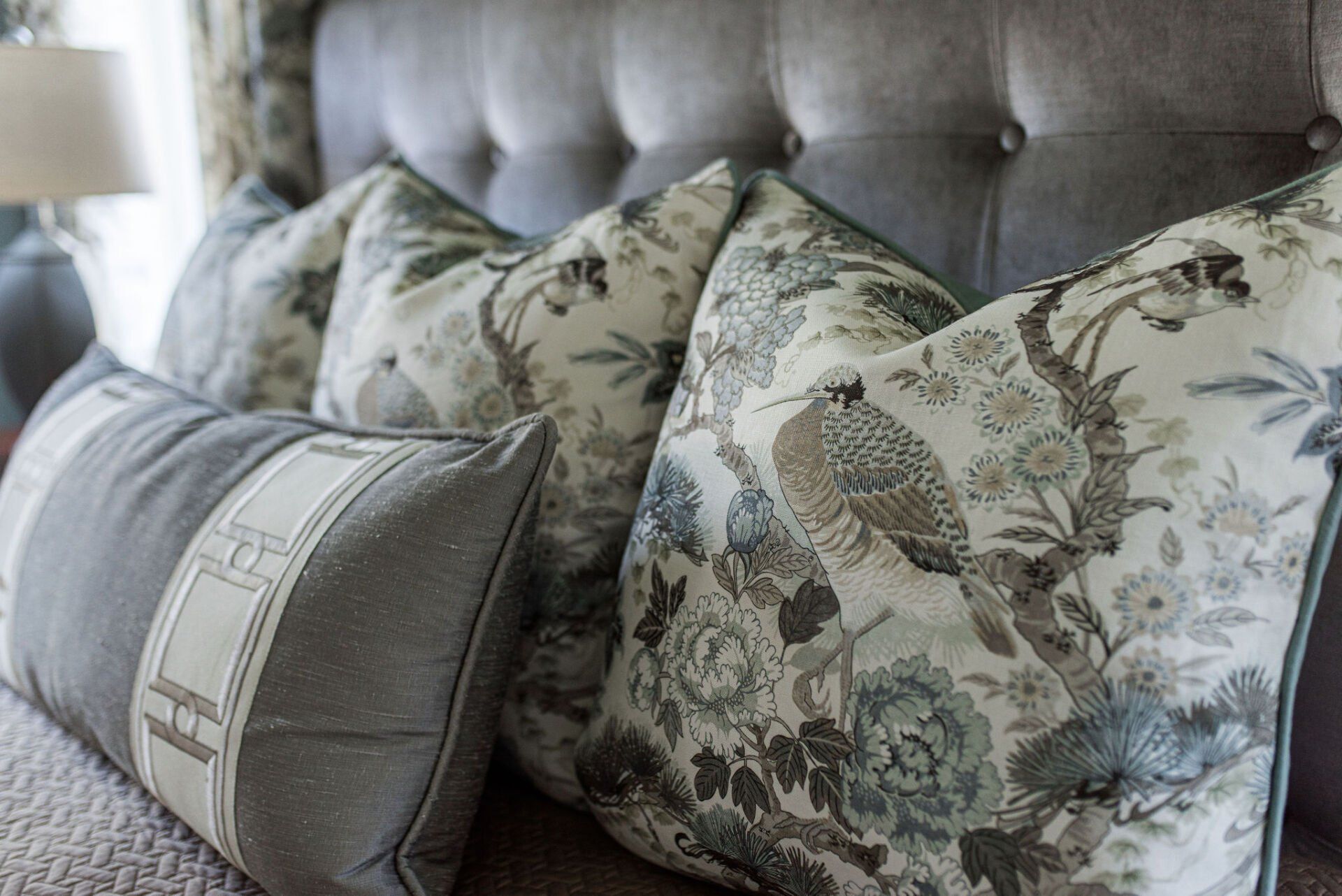 A bed with a lot of pillows on it.
