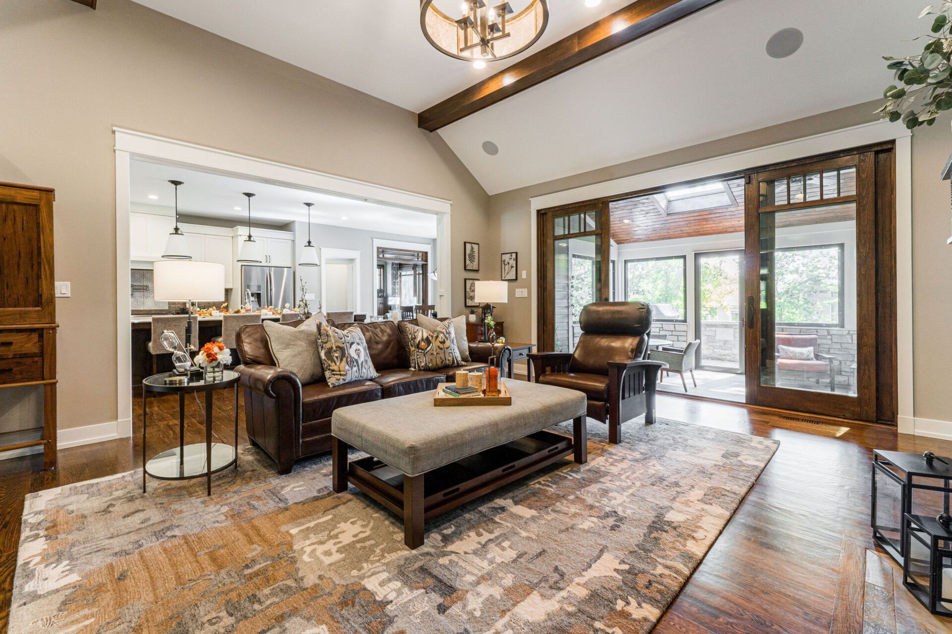 A living room with a couch , chair , coffee table and rug.