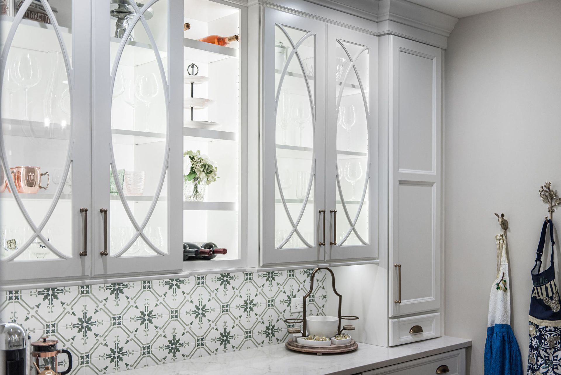 A kitchen with white cabinets and a sink.