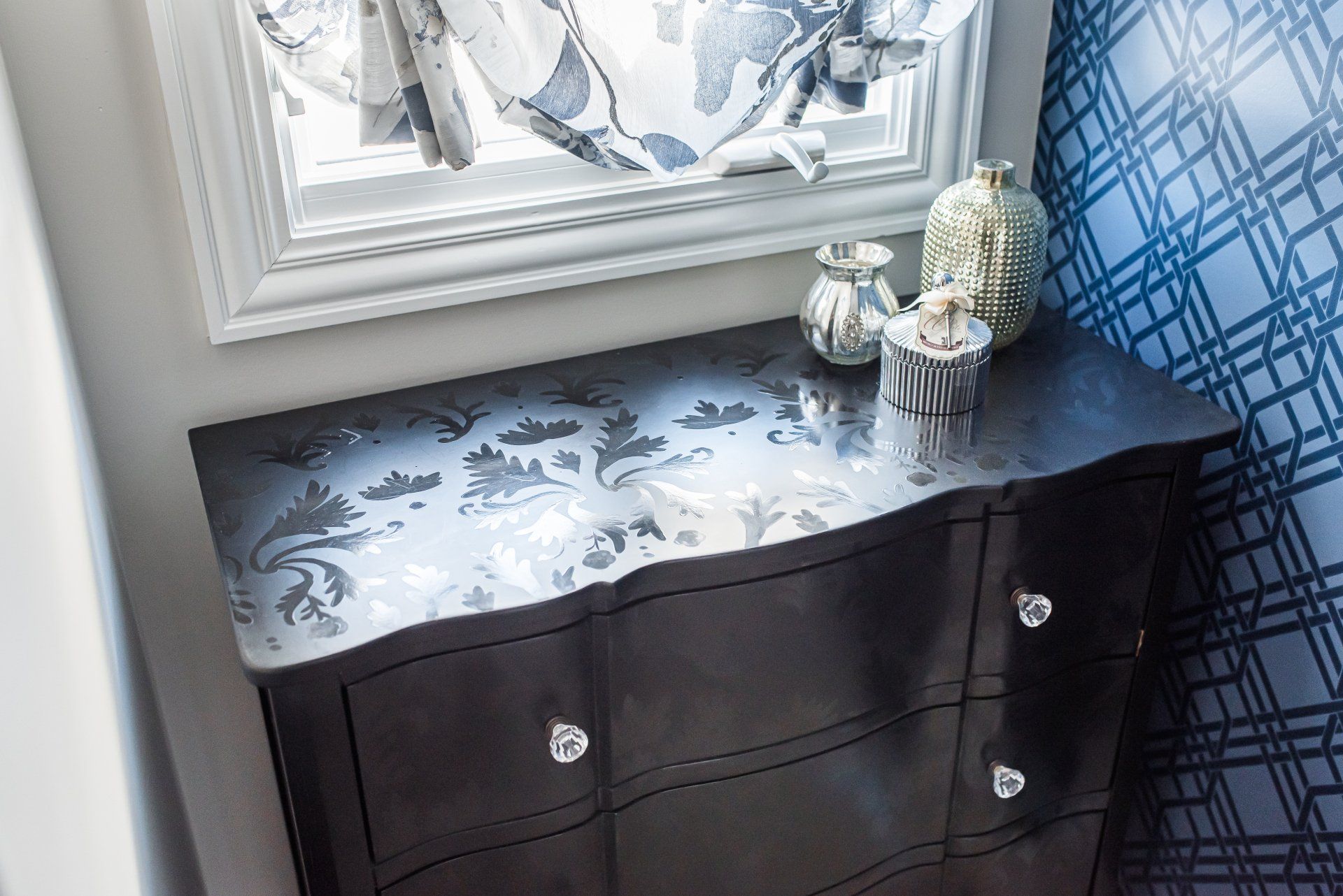 A dresser with a mirror and vases on top of it