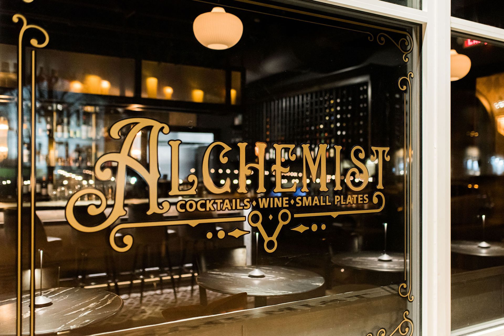 A restaurant with a sign that says alchemist on it