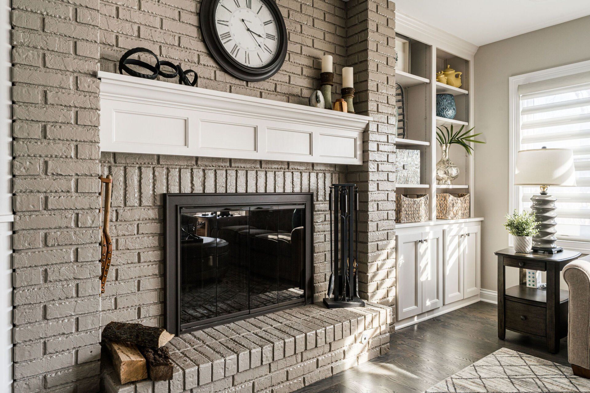 A living room with a fireplace and a clock on the wall.