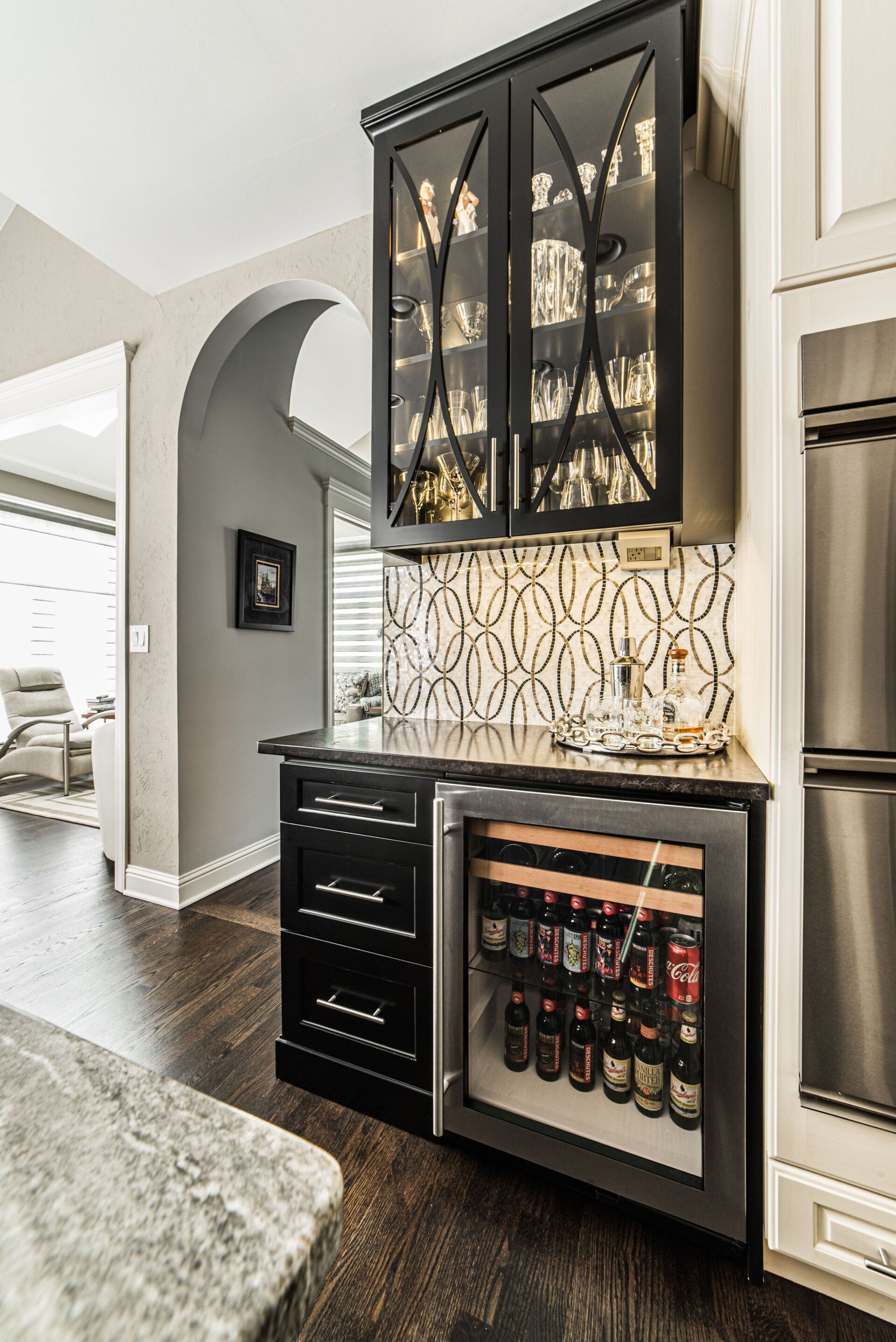A kitchen with stainless steel appliances and a wine cooler.