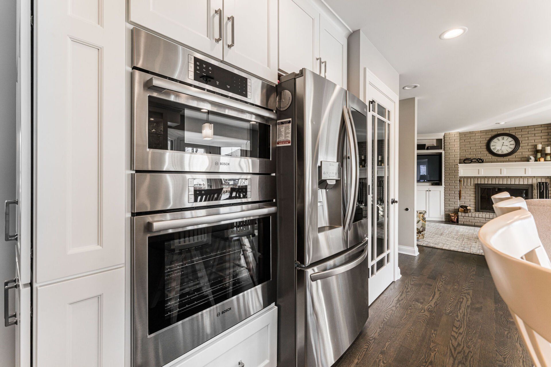 A kitchen with stainless steel appliances and white cabinets.