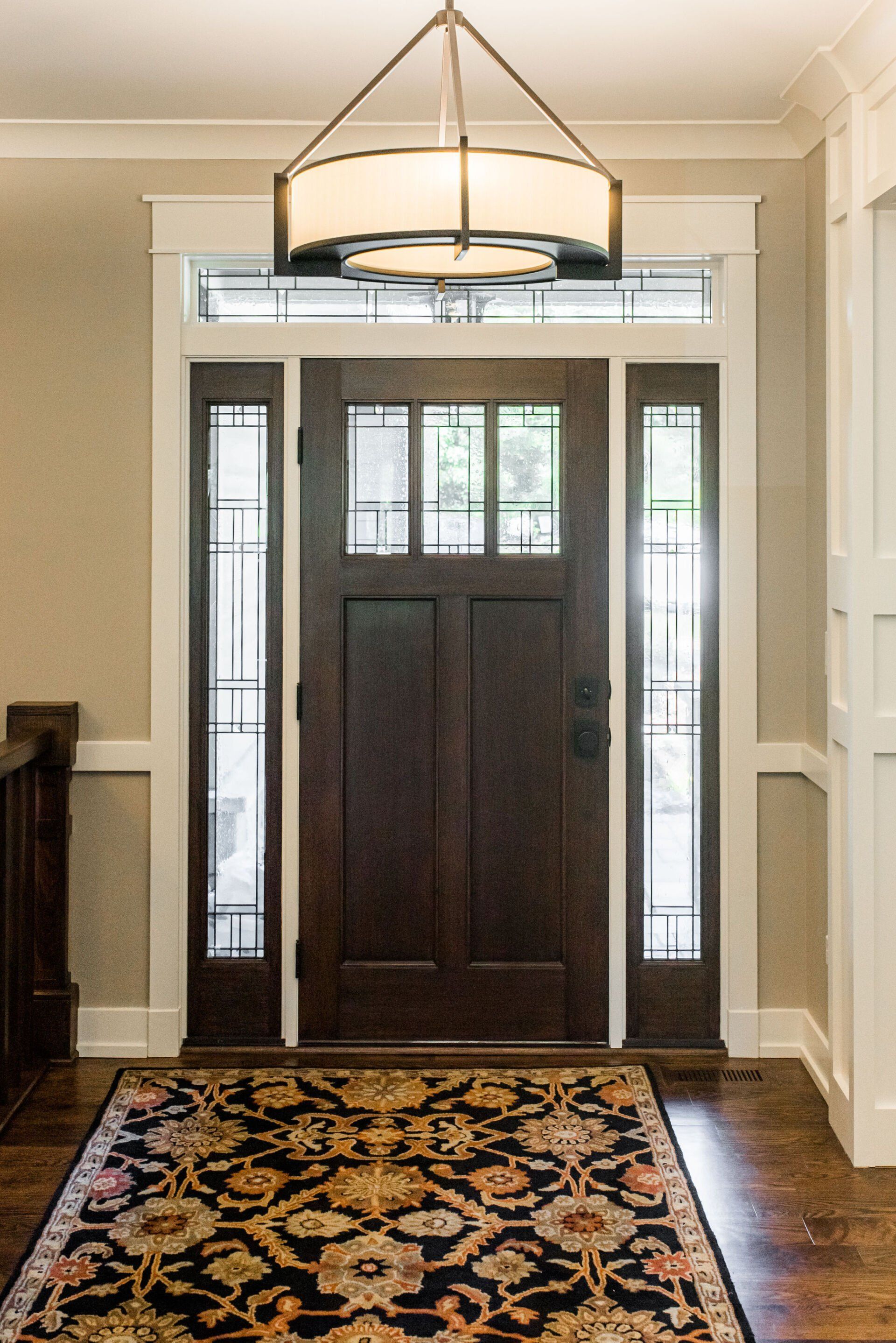 The front door of a house with a rug in front of it