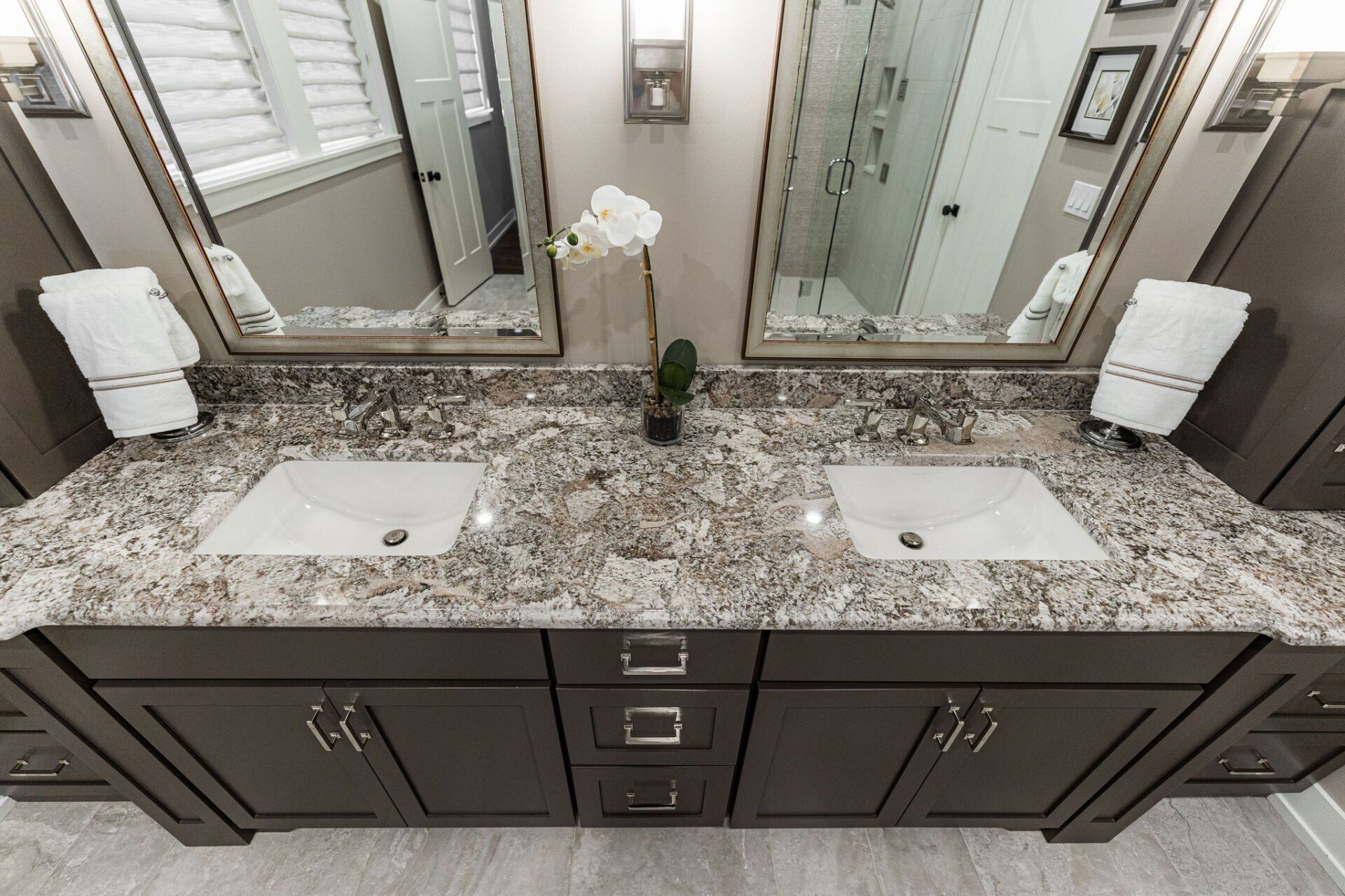 A bathroom with two sinks and two mirrors.