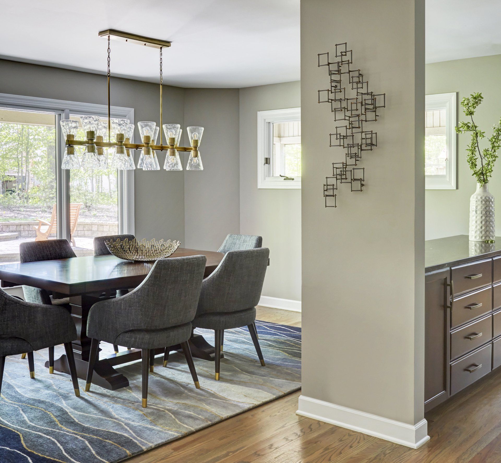 A dining room with a table and chairs and a chandelier