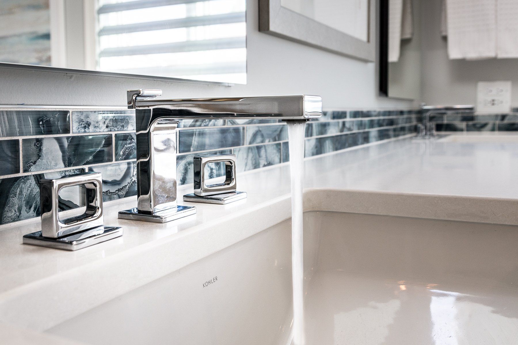 A bathroom sink with a faucet and a mirror.