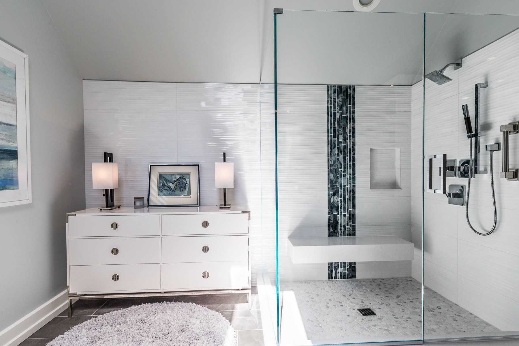 A bathroom with a walk in shower and a dresser