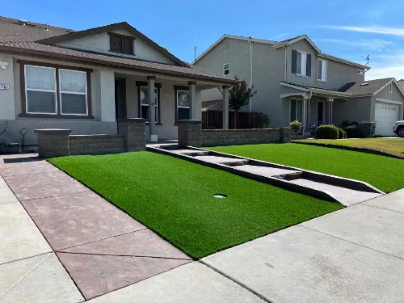 Suburban homes with neatly landscaped front lawns and driveways on a sunny day