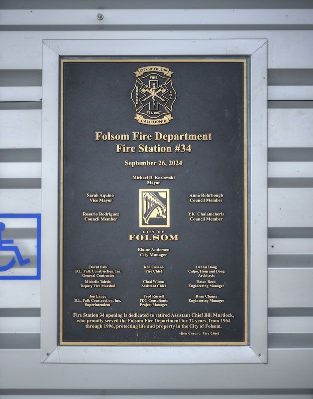 Plaque for Folsom Fire Department Fire Station 14, mounted on a gray wall.