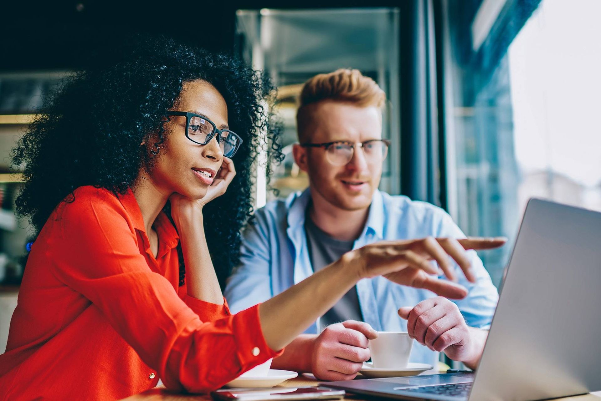 Dark,Skinned,Female,Graphic,Designer,Pointing,With,Finger,On,Laptop