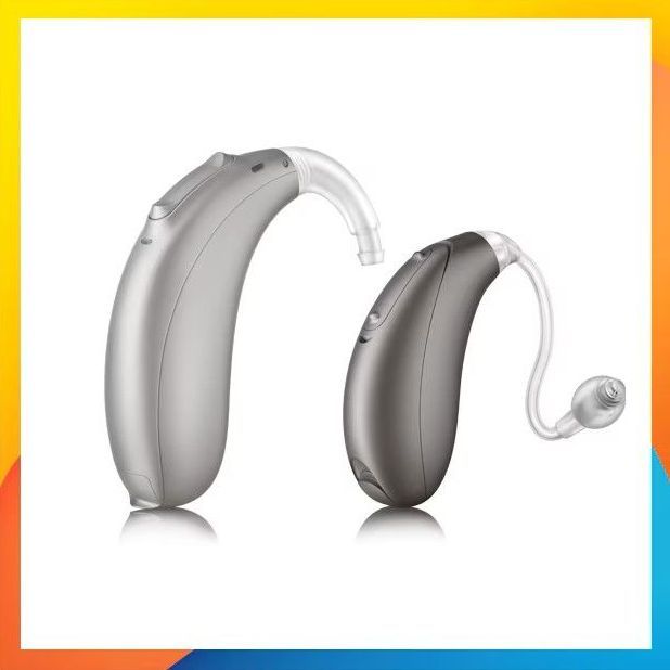 A row of hearing aids of different sizes and colors are lined up in a row.