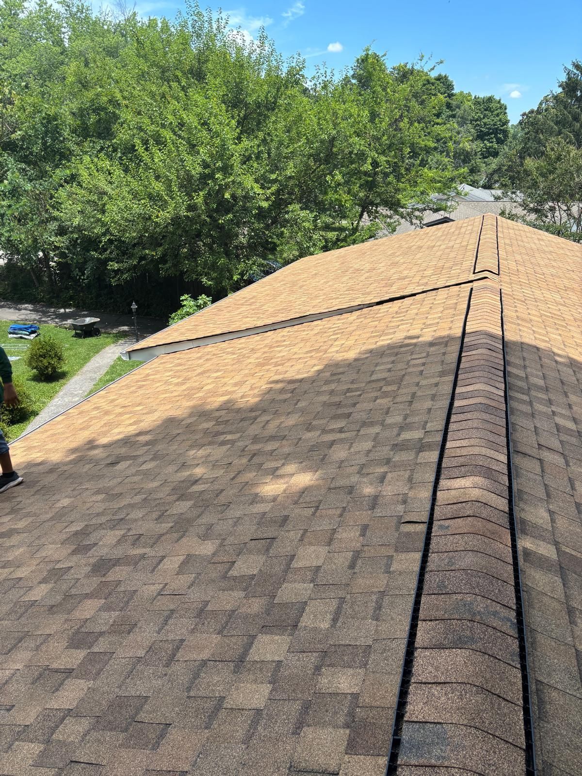 A man is standing on the roof of a house.