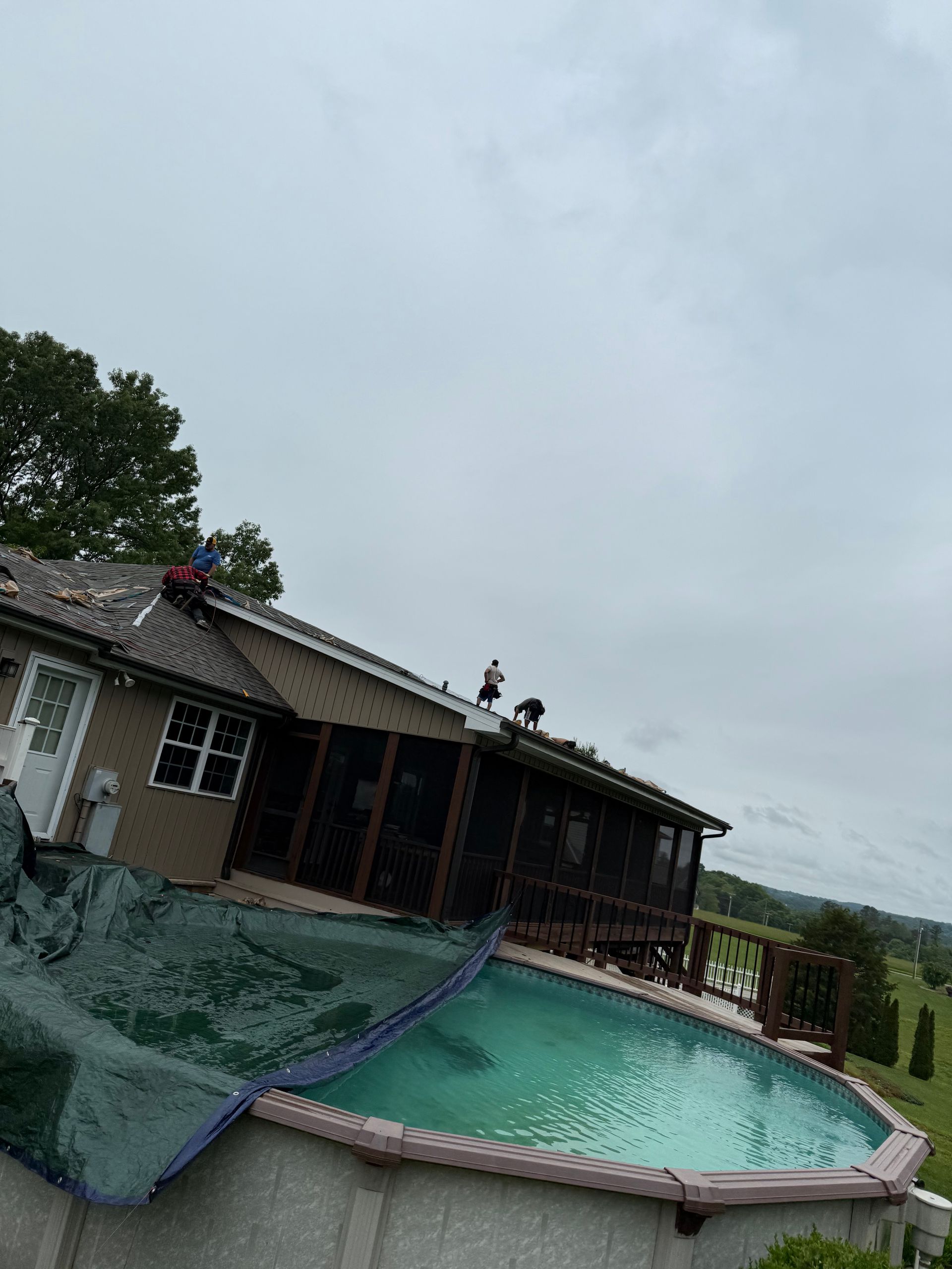A house with a swimming pool in front of it.
