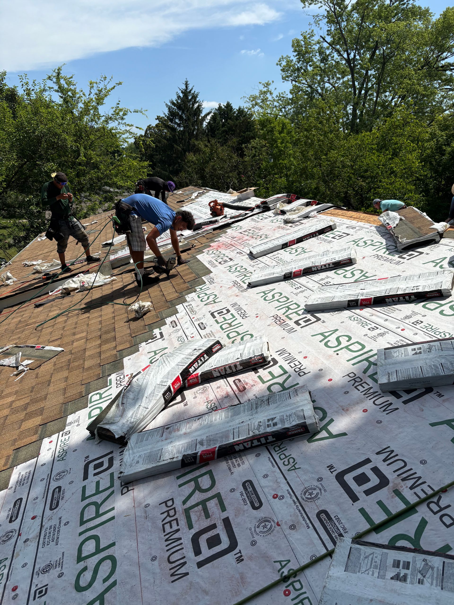 A group of people are working on a roof.