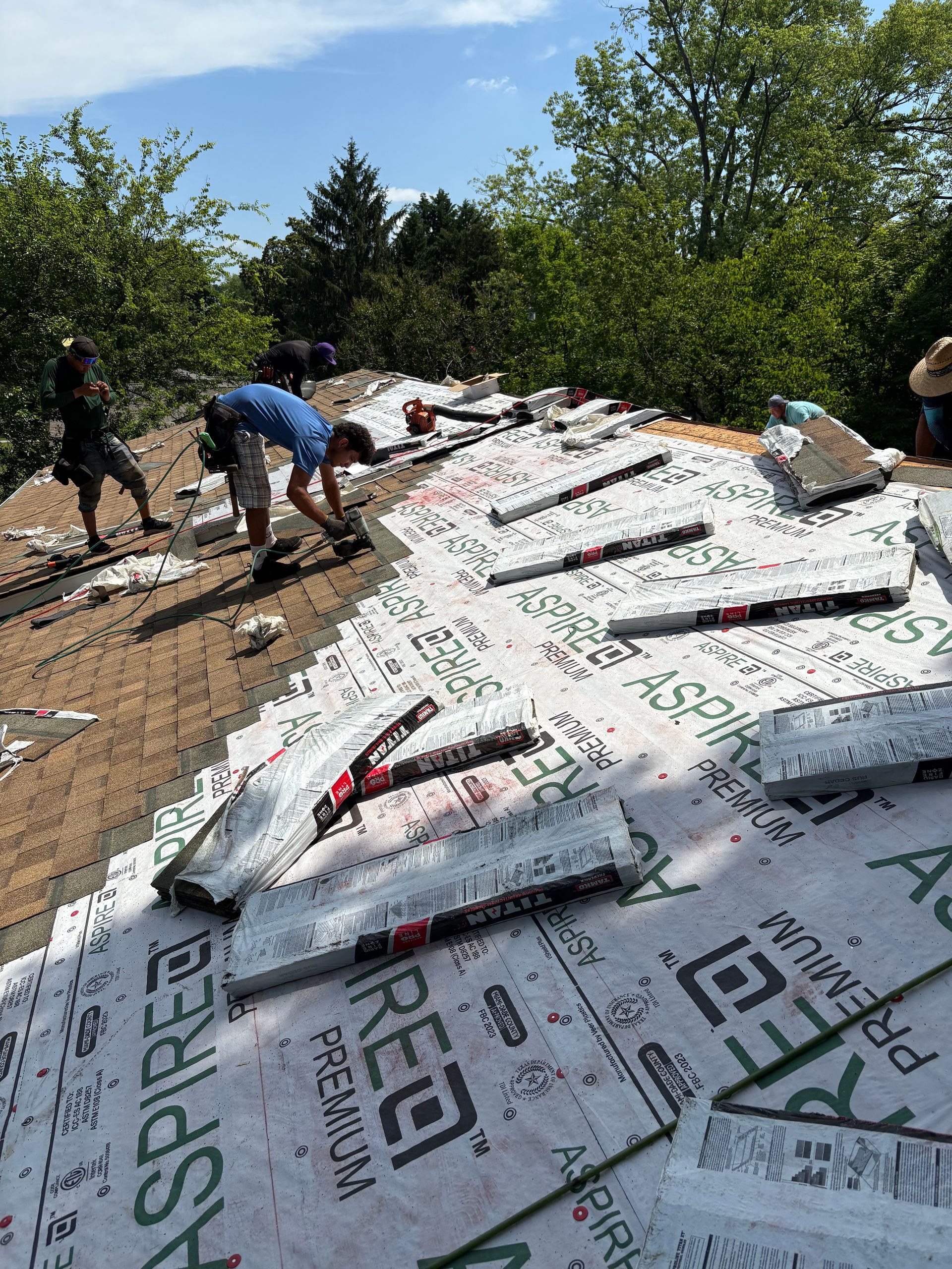 A group of people are working on a roof.