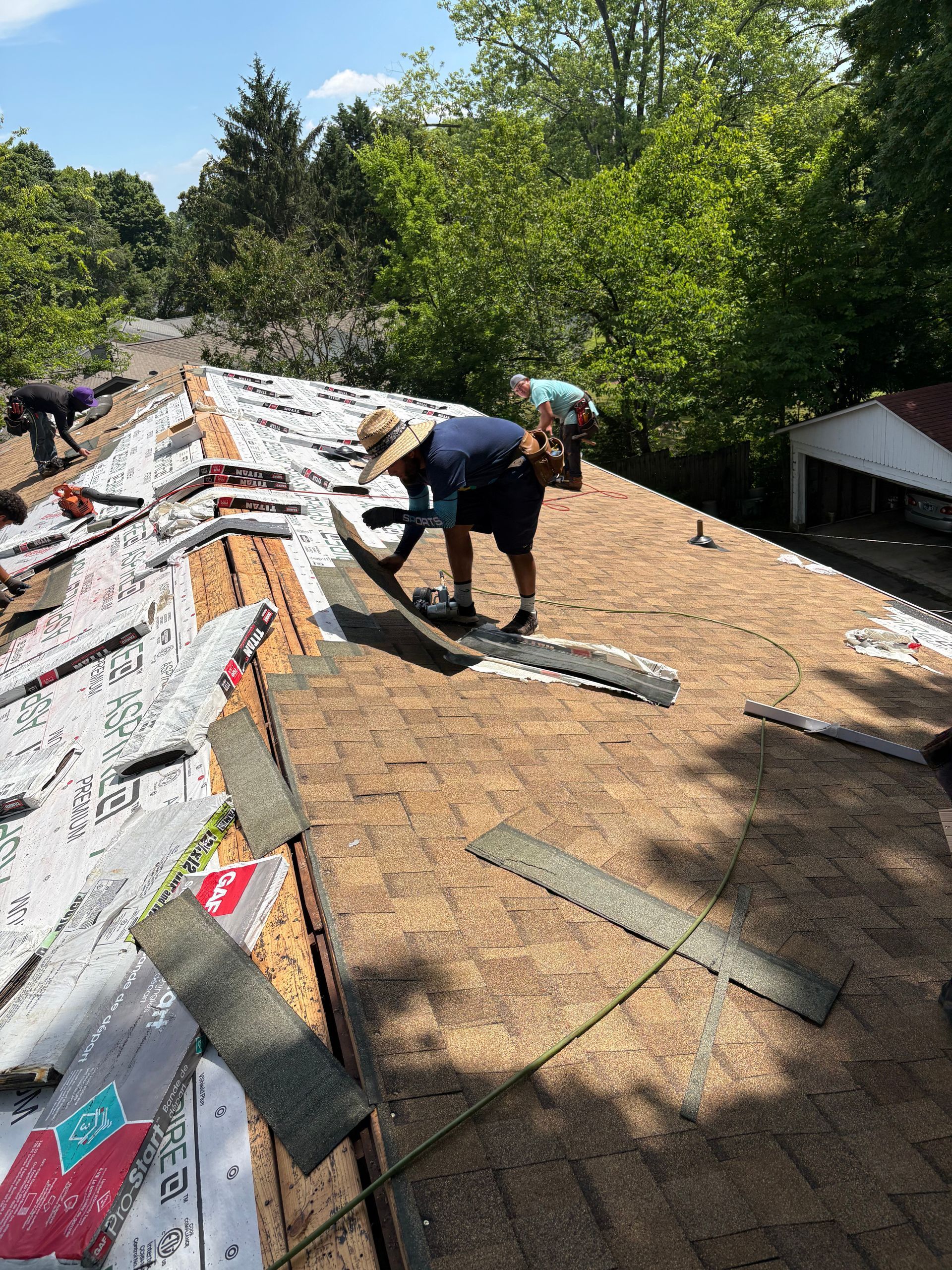 A group of people are working on a roof.