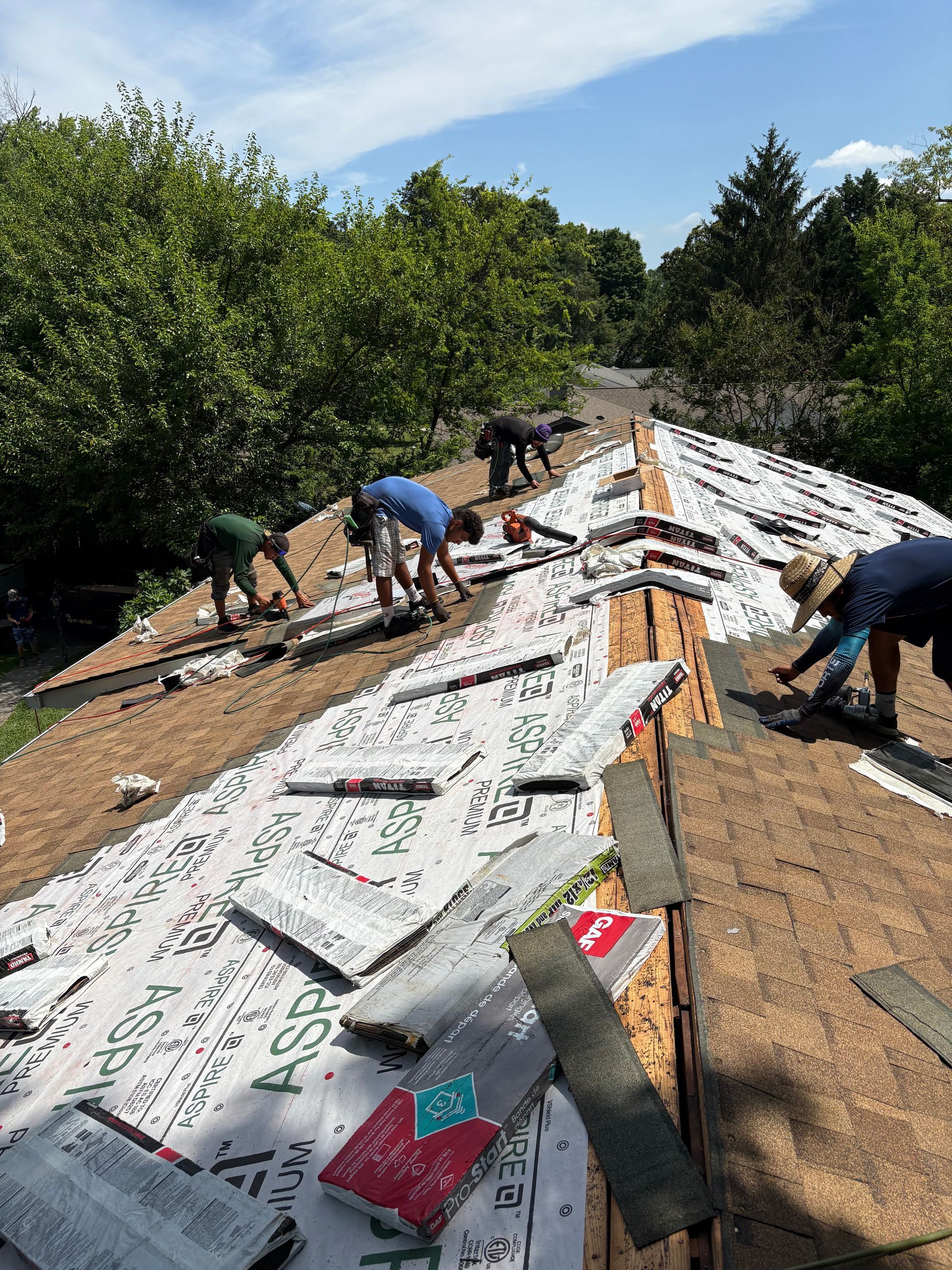 A group of people are working on a roof.
