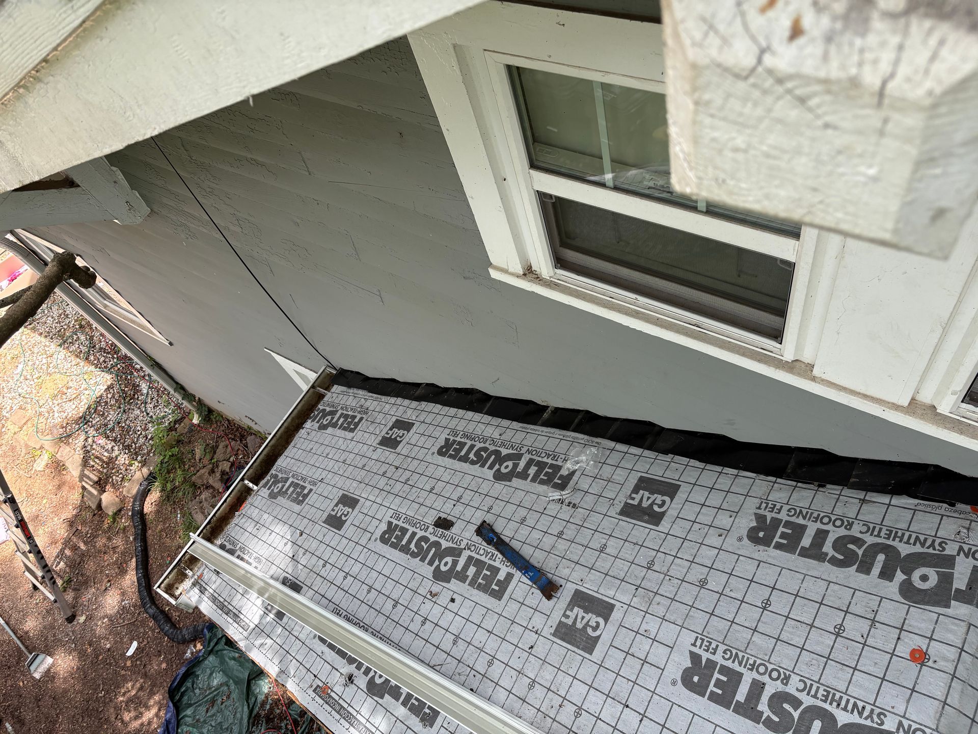 An aerial view of a house with a roof being installed.