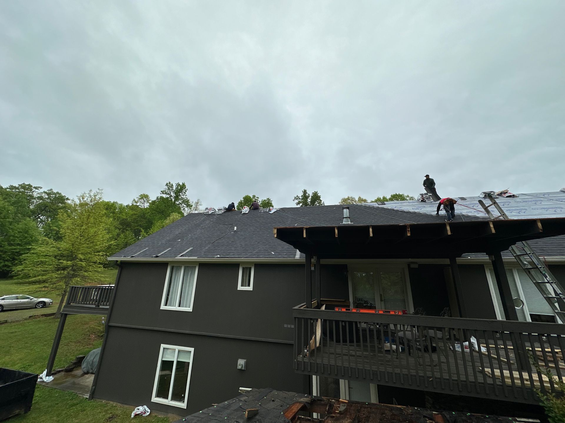A man is working on the roof of a house.
