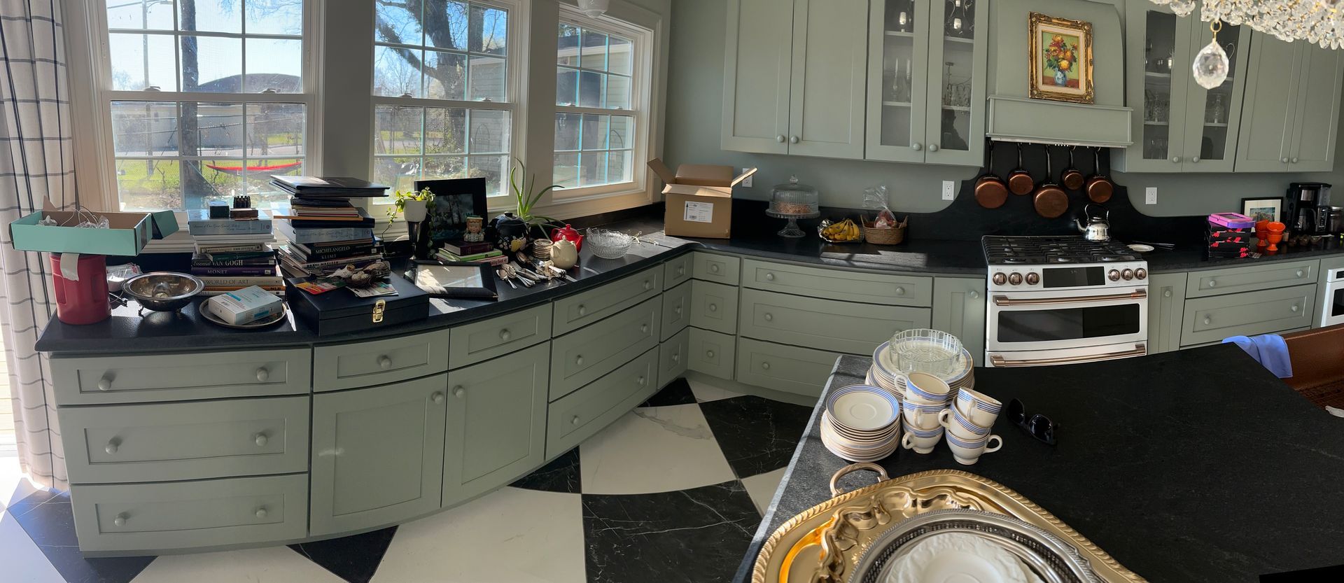 A kitchen with a black and white checkered floor and cabinets