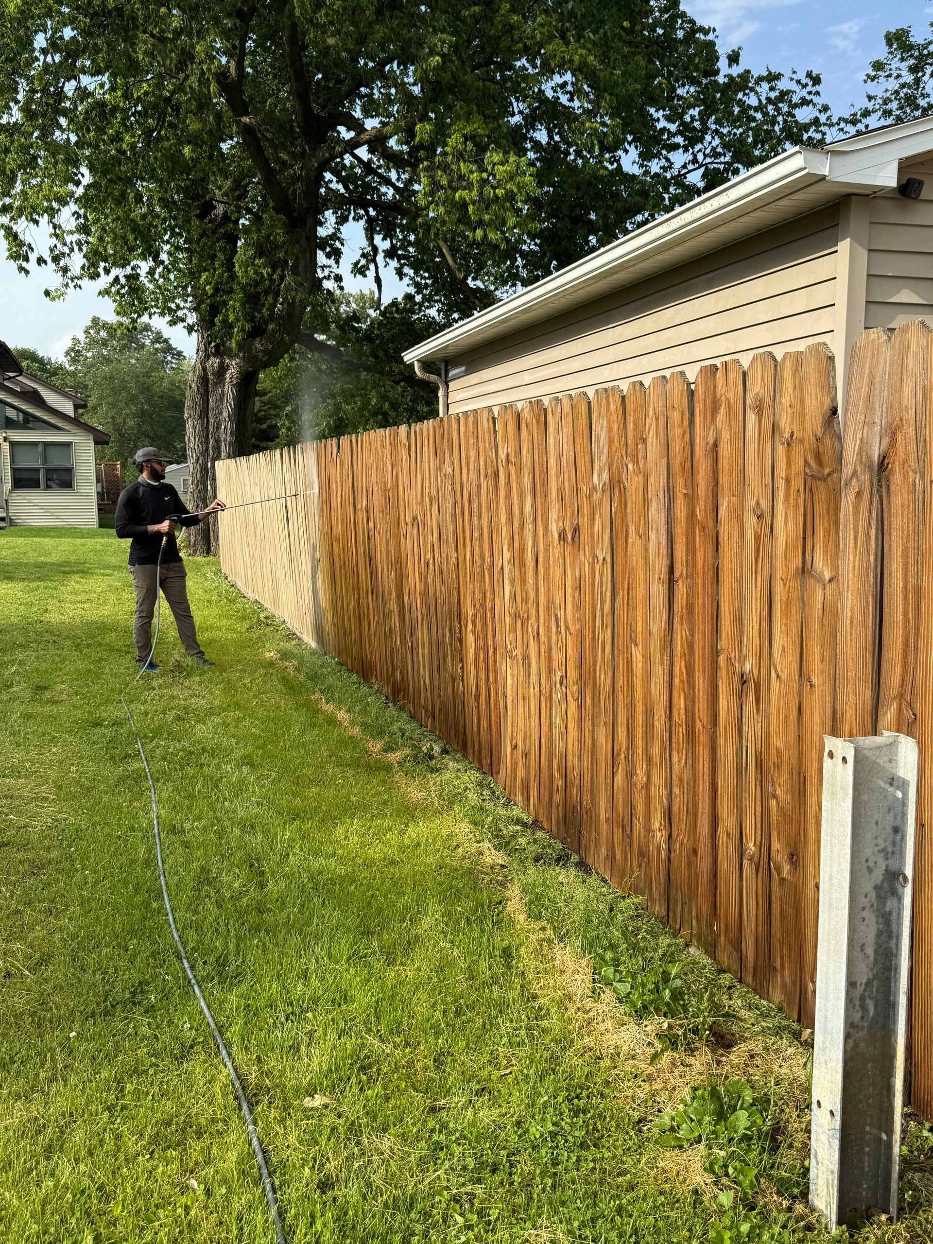 Person Power Washing a Wooden Fence — Springfield, IL — Midwest Power/Soft Washing