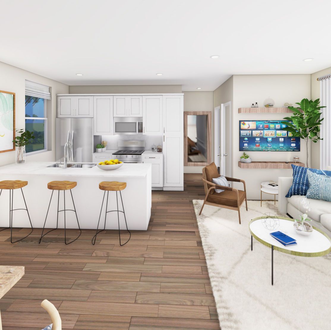 Open-concept kitchen and living room with white cabinets, wood floors, and neutral-toned furniture.