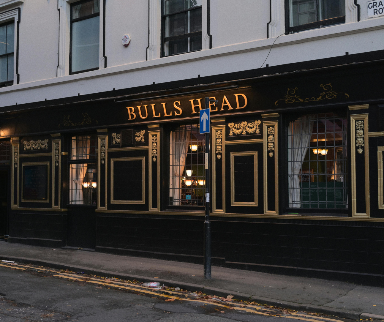 Bulls Head pub storefront with black-and-gold trim on a city street