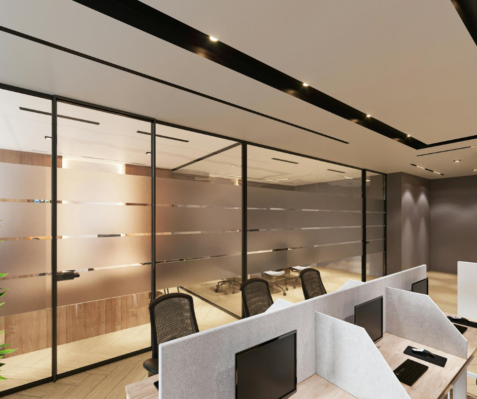 Modern office interior with glass partitions, desks, and black chairs