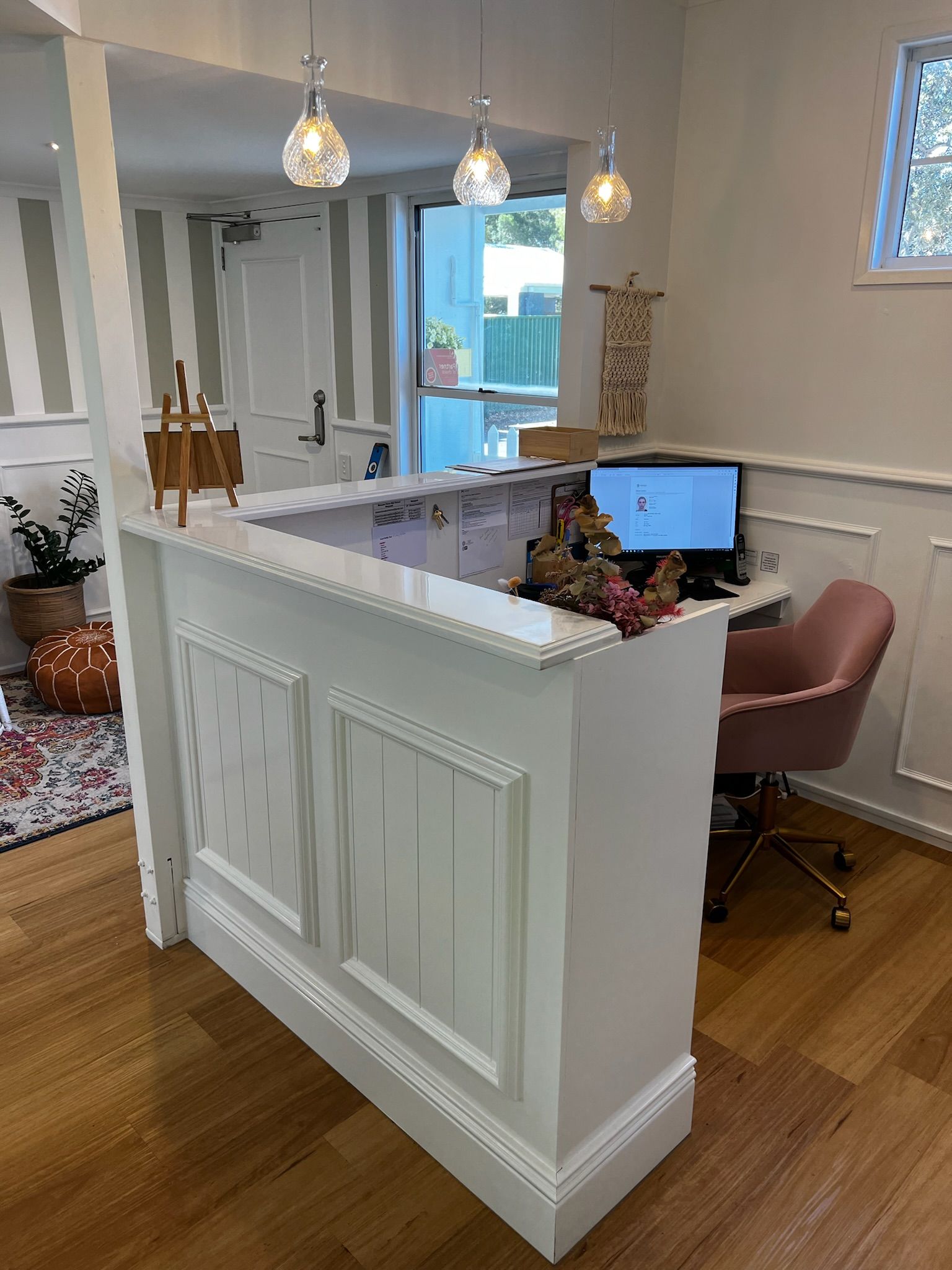 There is a desk with a computer on it in the middle of the room.