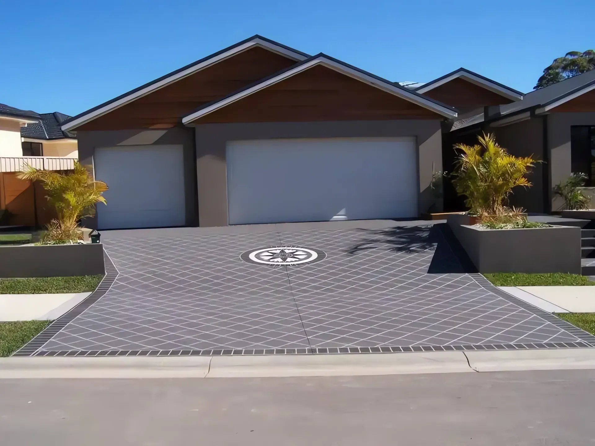 Modern House With Three-car Garage and a Patterned Driveway — Concrete Colour Solutions in Denman, NSW