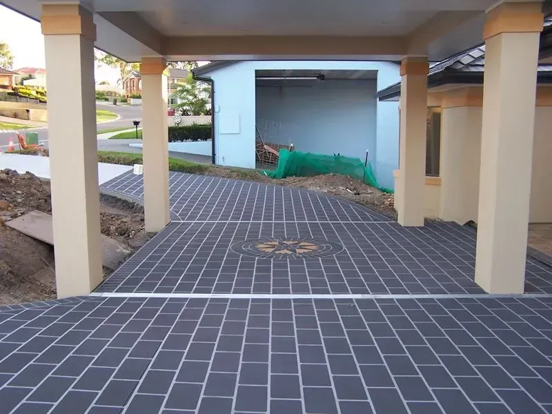 Covered Patio With Cream Columns and Patterned Gray Tile Floor — Concrete Colour Solutions in Dungog, NSW