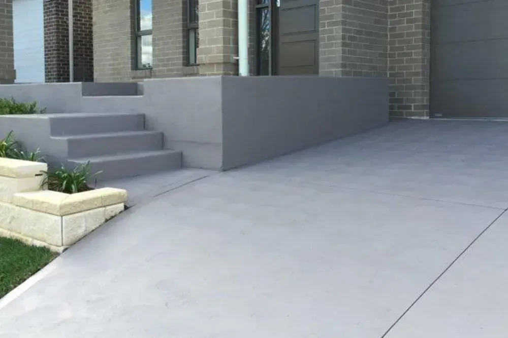 Modern House Entrance With Gray Concrete Steps and Retaining Wall — Concrete Colour Solutions in Singleton, NSW