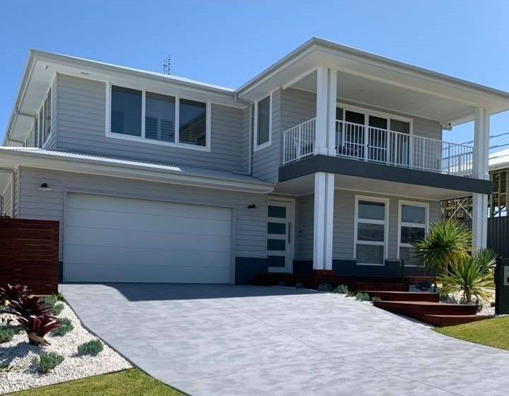 A Large House with A Driveway Leading to It — Concrete Colour Solutions in Raymond Terrace, NSW