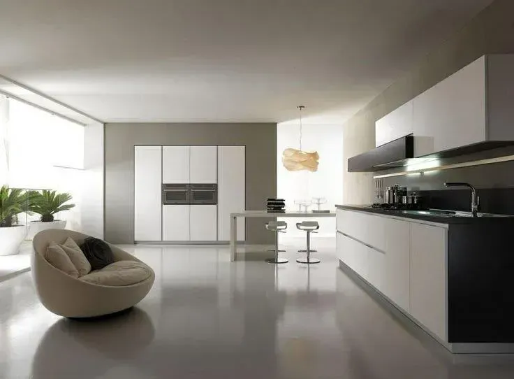 A kitchen with white cabinets and black counter tops — Concrete Colour Solutions in Morisset, NSW