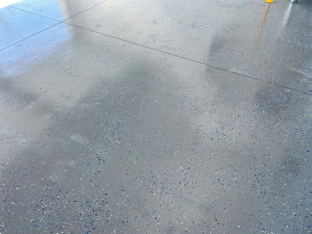 A Gray Concrete Floor with A Lot of Small Dots on It — Concrete Colour Solutions in Maitland, NSW