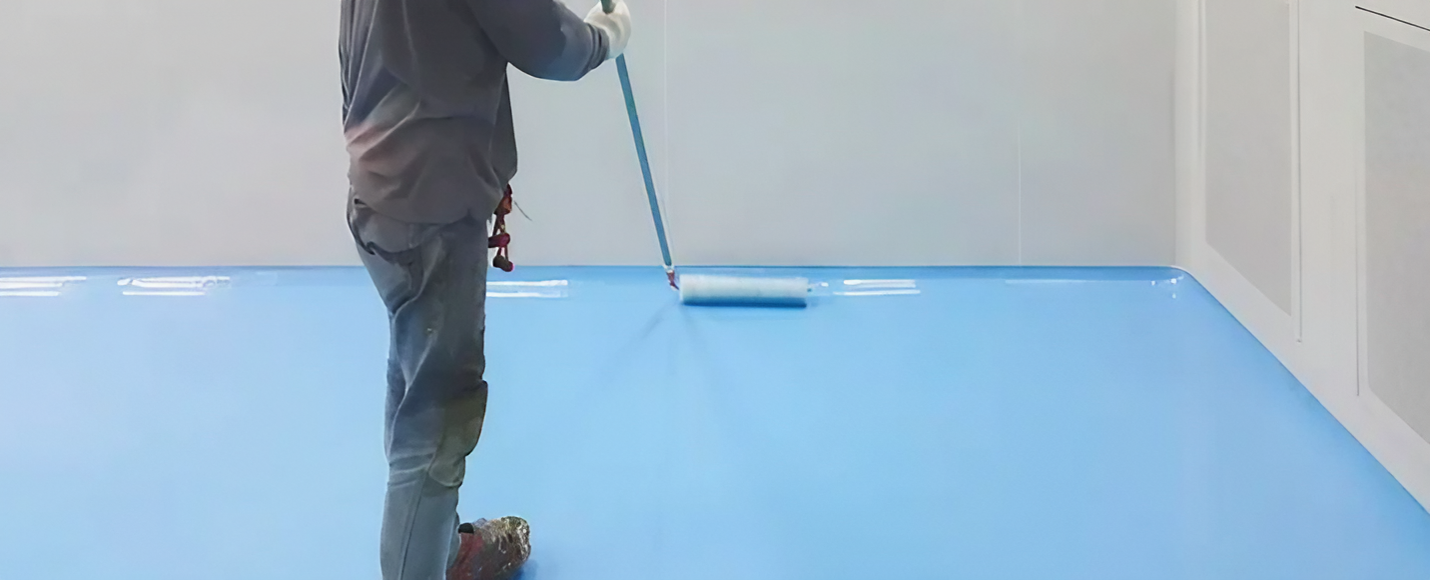 Person Rolling Bright Blue Floor Coating in an Empty Room — Concrete Colour Solutions in Dungog, NSW