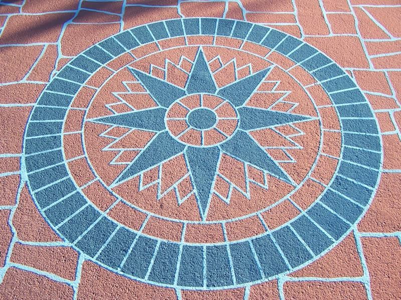A Circular Pattern on A Brick Floor with A Star in The Center — Concrete Colour Solutions in Heatherbrae, NSW
