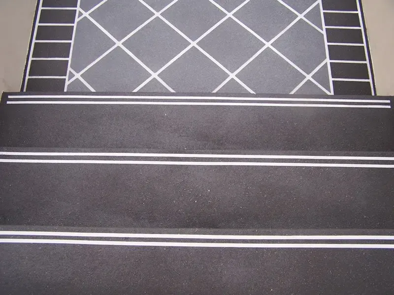 A set of black stairs with white stripes on the bottom — Concrete Colour Solutions in Morisset, NSW