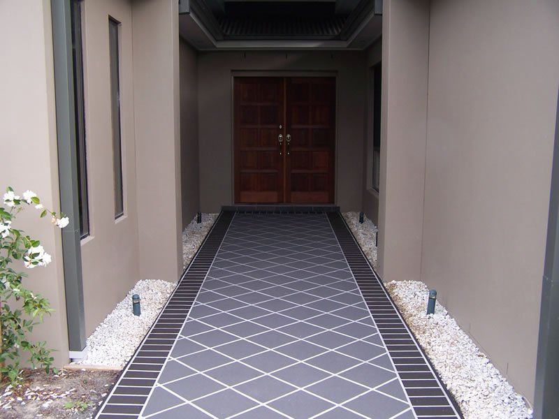 A Walkway Leading to The Front Door of A House — Concrete Colour Solutions in Morisset, NSW