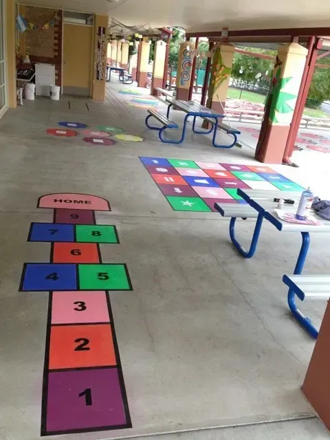 Colorful Hopscotch Mats and Numbered Floor Games in a Covered School Hallway — Concrete Colour Solutions in Muswellbrook, NSW