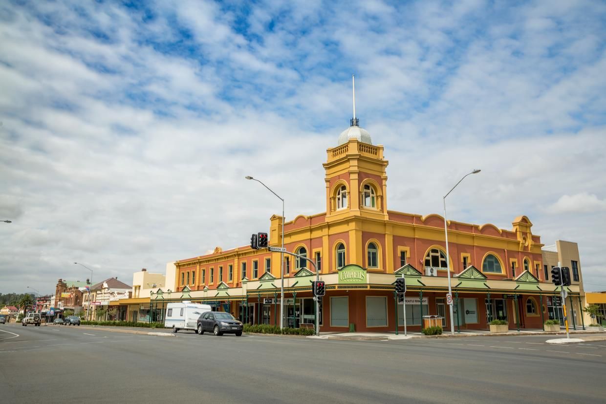 Historic Corner Building on a Quiet Street Under a Partly Cloudy Sky — Concrete Colour Solutions in Muswellbrook, NSW