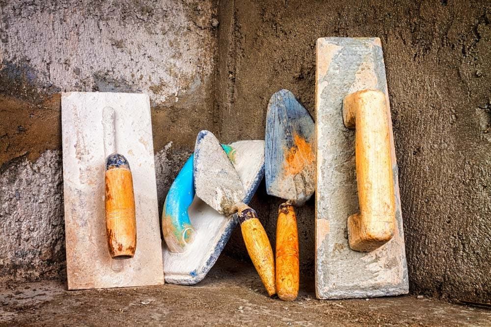 A Group of Construction Tools Sitting on Top of A Concrete Surface — Concrete Colour Solutions in Heatherbrae, NSW