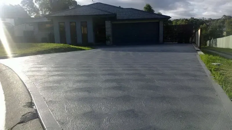 A Driveway Leading to A House with A Garage — Concrete Colour Solutions in Maitland, NSW