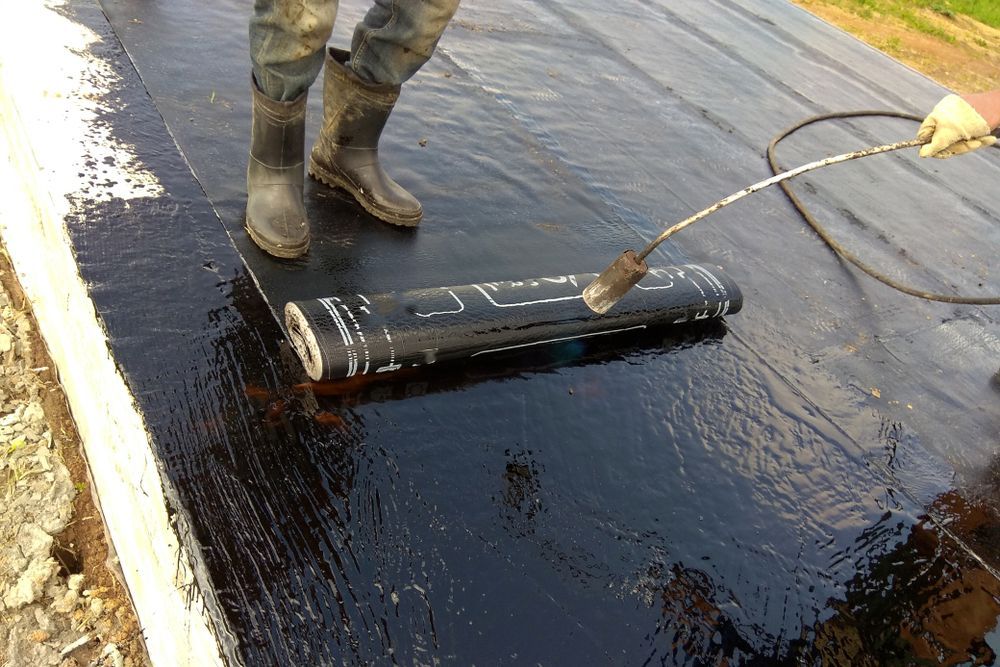 Worker in Boots Doing Concrete Sealing