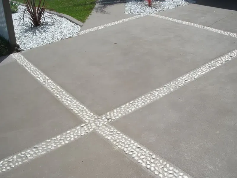 A close up of a concrete driveway with white lines on it. — Concrete Colour Solutions in Morisset, NSW